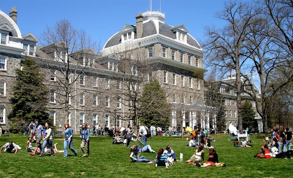 The Swarthmore College campus with students resting on the lawn.
