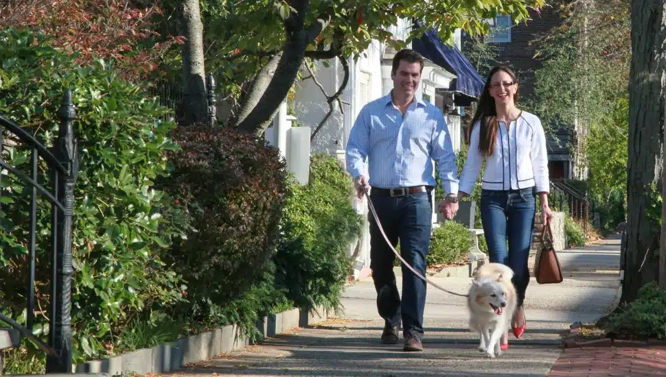 A couple walking their dog.
