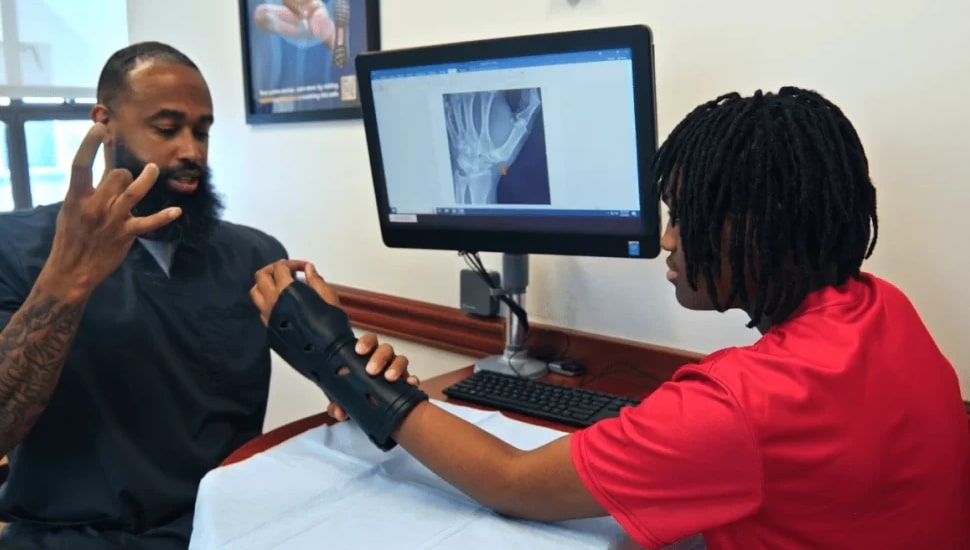 Fitting the 3D printed cast to a patient.