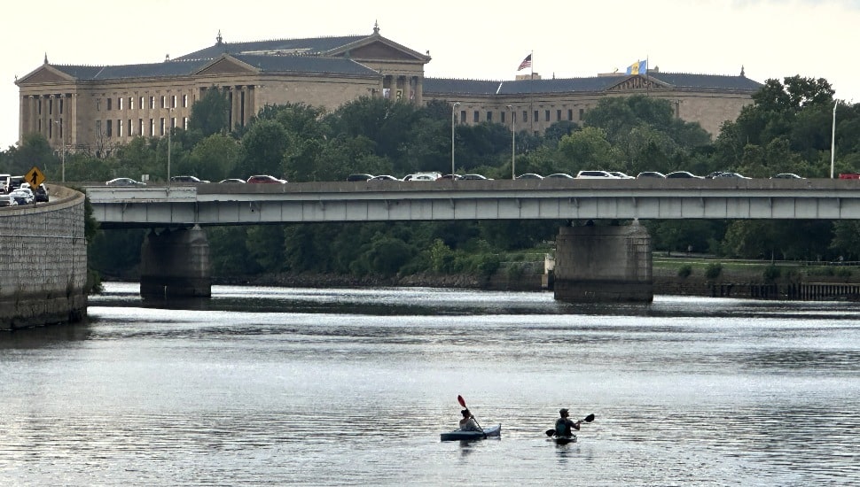 Kyakers on The Schuylkill River with the Philadelphia Museum of Art looming in the background.