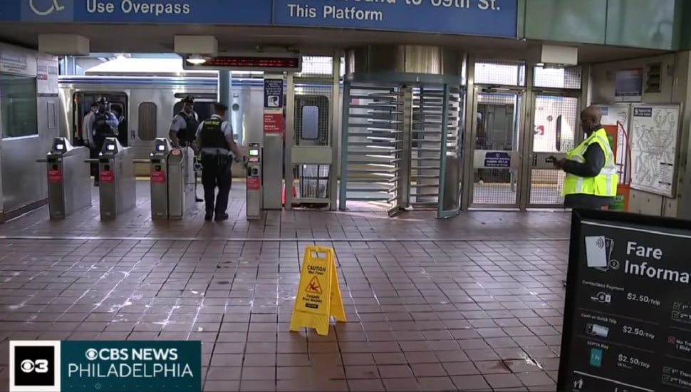 Inside a SEPTA subway station with police near the turnstiles.