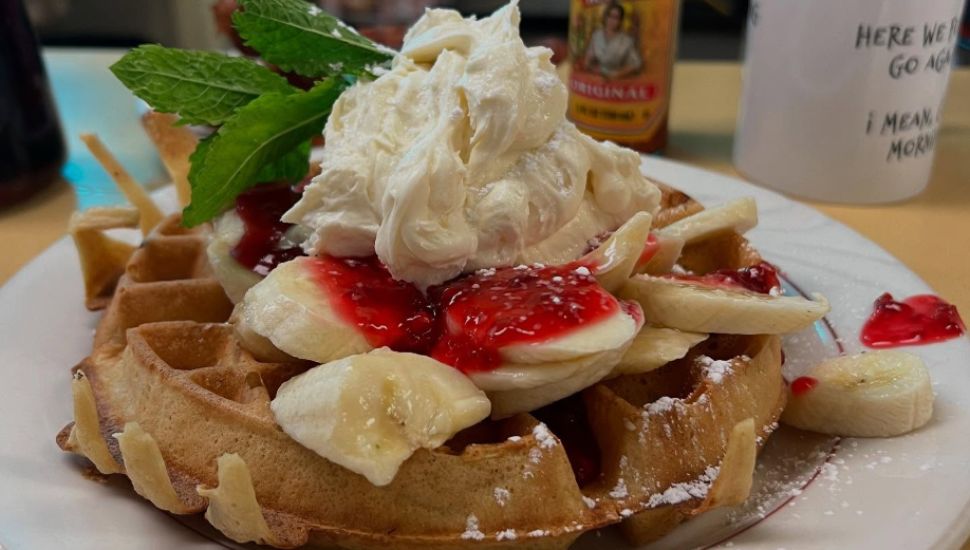 Belgian waffle with raspberry sauce, bananas and whipped vanilla mascarpone.