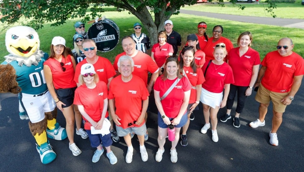 Group photo of bank volunteers in red shirts.