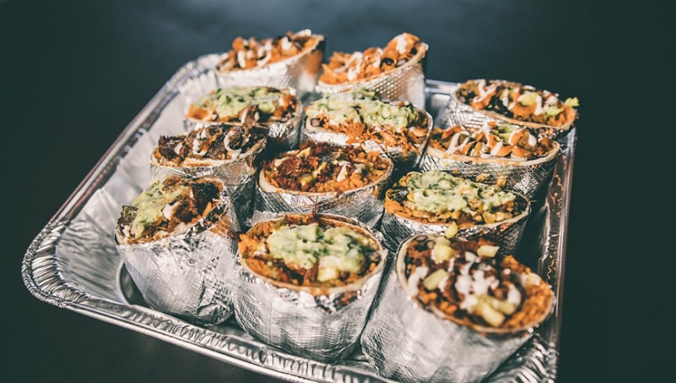 A tray filled with 12 burritos from Tacoria Mexican Street Kitchen.
