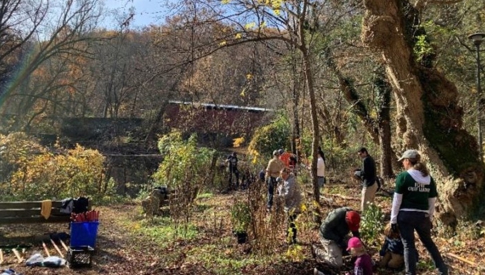 Volunteers clean up a park.