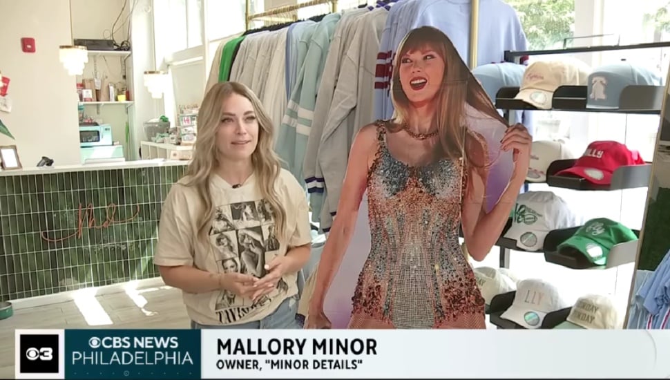 Mallory Minor talking with a cardboard cutout of Taylor Swift to her left.