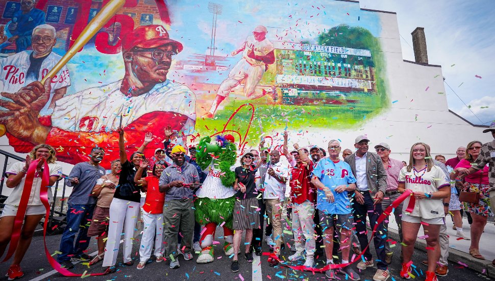 Phillies, Mural Arts, elected officials, fans in front of the new Dick Allen mural with confetti falling.