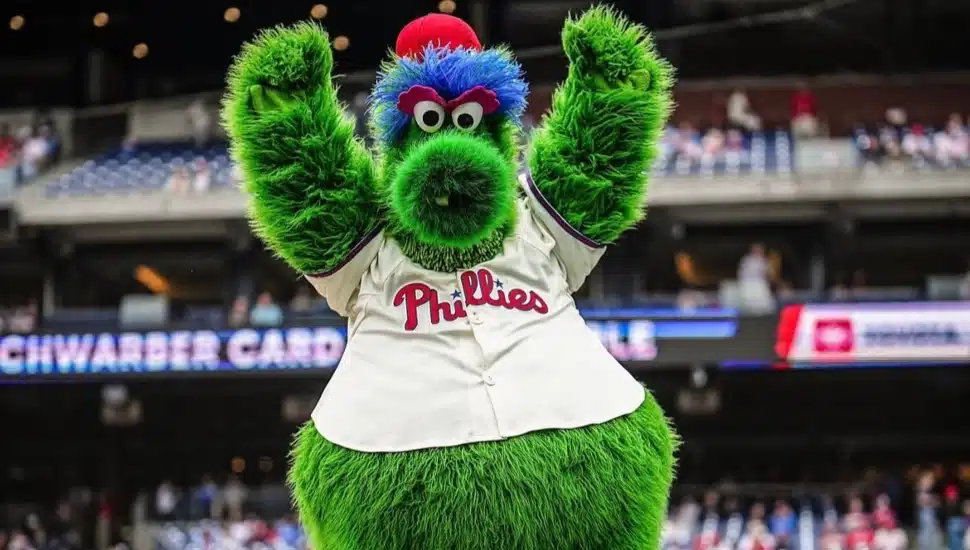 Phillie Phanatic raising arms in the air.