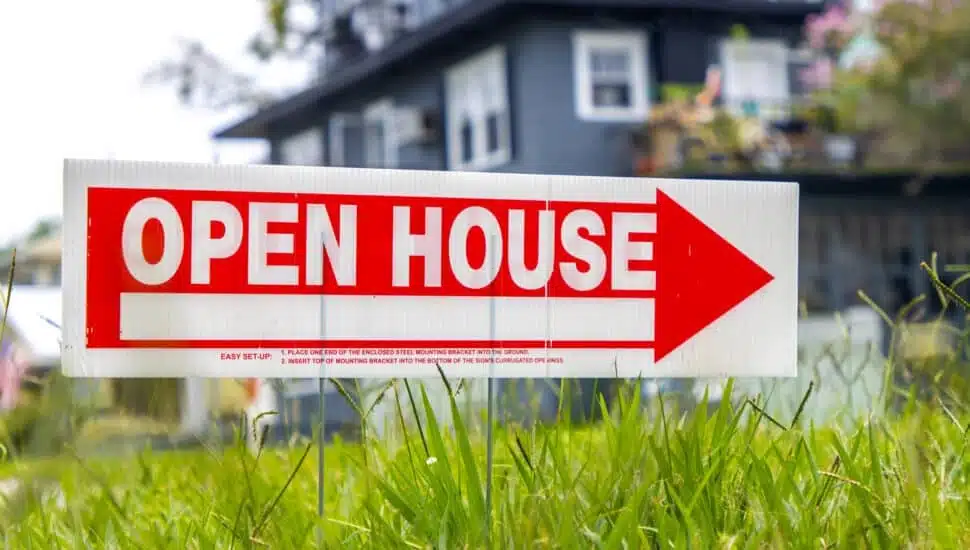 Open house sign on grass.