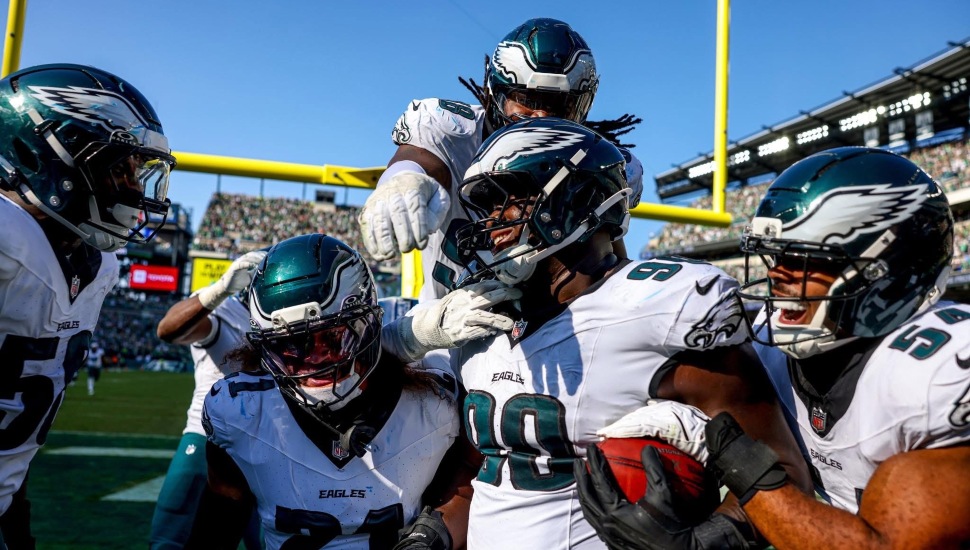 Jordan Davis being celebrated by his teammates in the end zone after Eagles' win against the Rams.