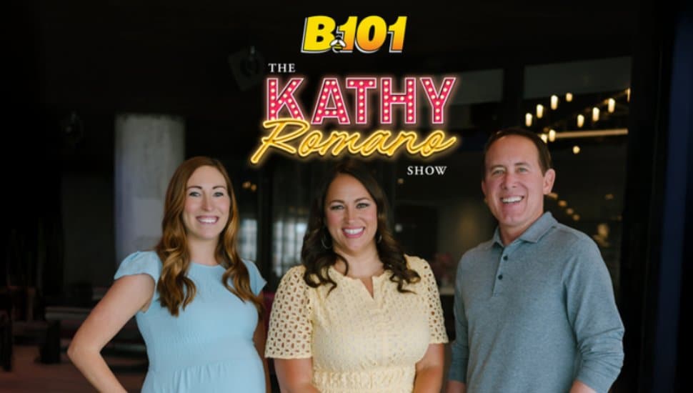 Kathy Romano stands with her co-hosts Bobby Smith and Laura Boss