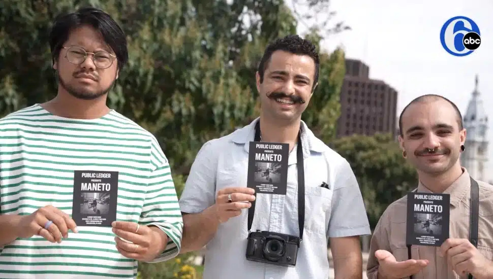 Founders of Public Ledger holding flyers for upcoming event.