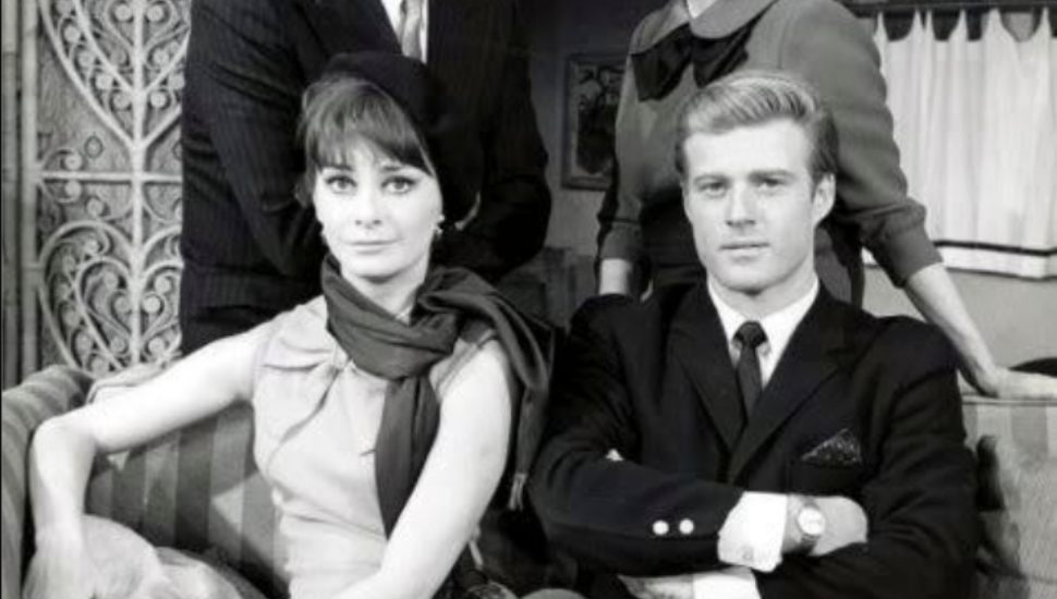 Robert Redford and Elizabeth Ashley sitting beside each other.