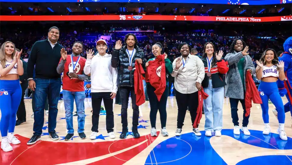 Wilt Chamberlain Memorial Fund scholars at center court inside the former Wells Fargo Center.