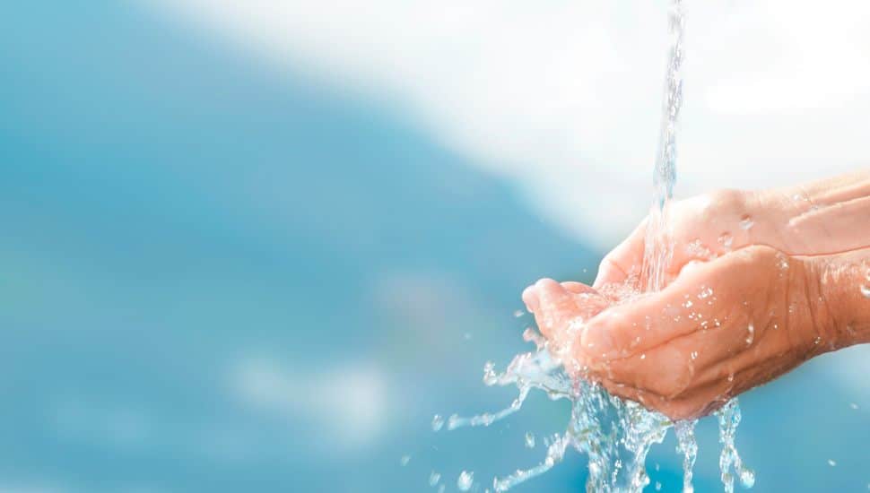 Clean water overflowing on hands.