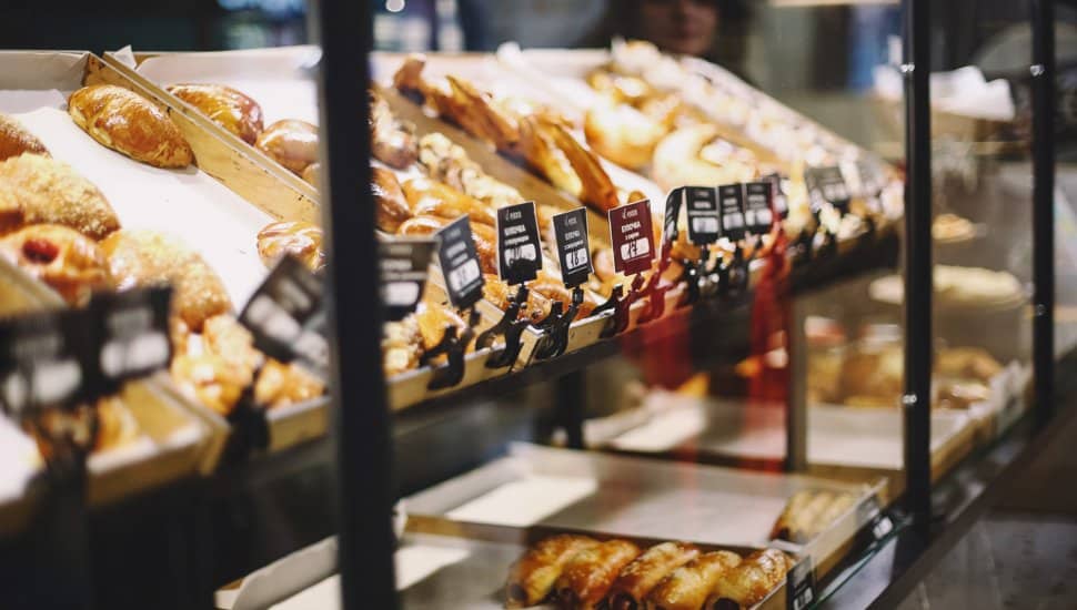 Close up picture of buns on the counters of a pastry shop.
