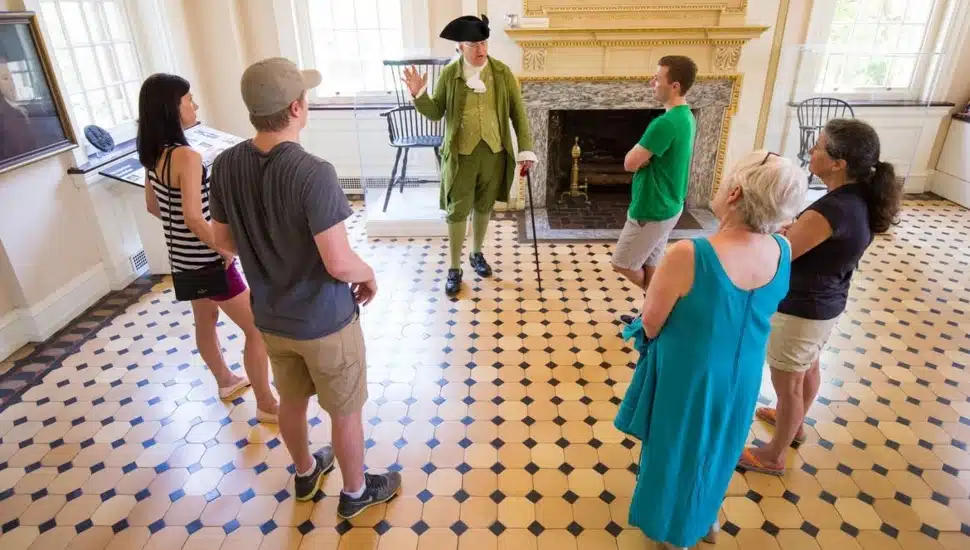 A guide speaking with guests inside Carpenters' Hall.