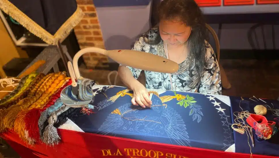 A woman creating a flag.