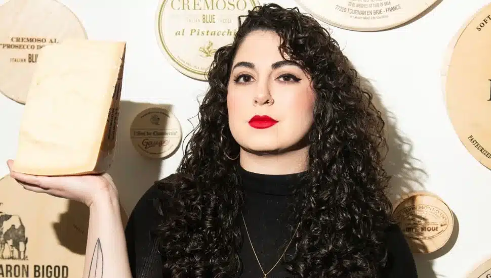 Emilia D'Albero holding a block of cheese.