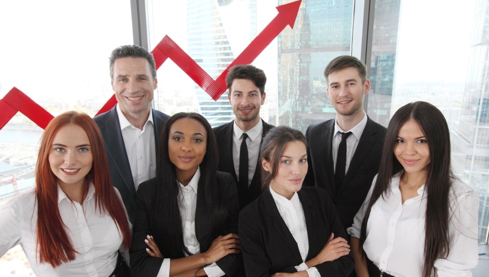 Portrait of business team of men and women in office with arrow graph of income growth