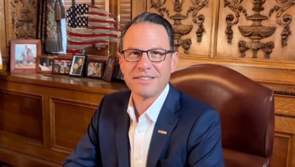 Josh Shapiro sits behind his desk.