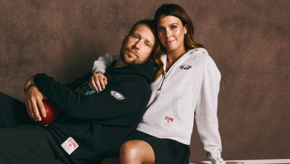 Nick Foles embraced by his wife, Tori, both of whom are wearing new Philadelphia Eagles gear from Lululemon.