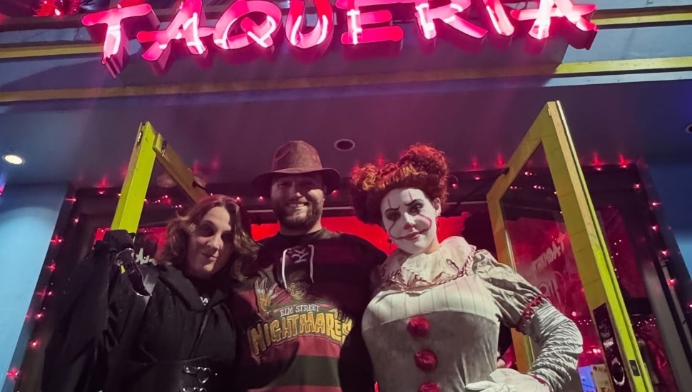 People in costumes outside Taqueria Amor in Manayunk.