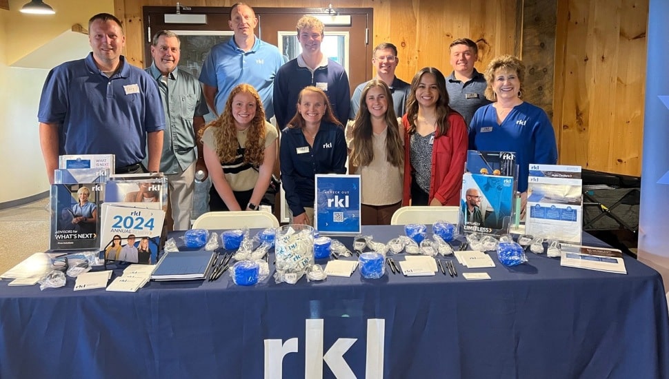 Group photo at company's promotional table.