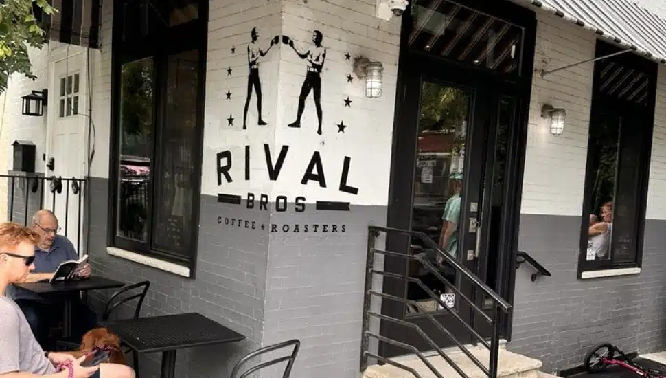 Rival Bros Coffee exterior with people sitting at the tables inside.