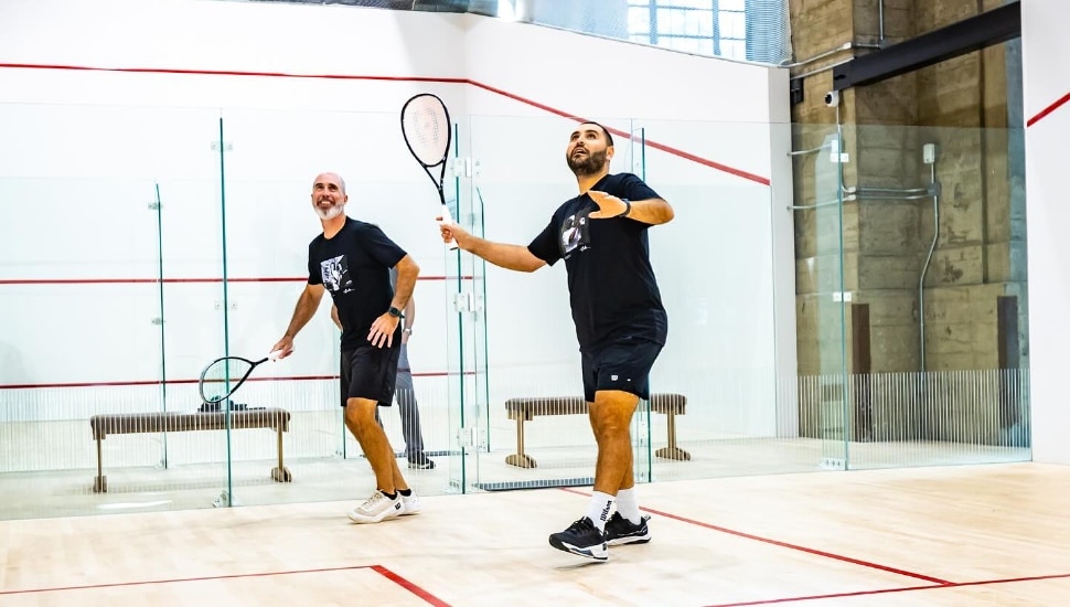 Two guys playing racketball at Ballers