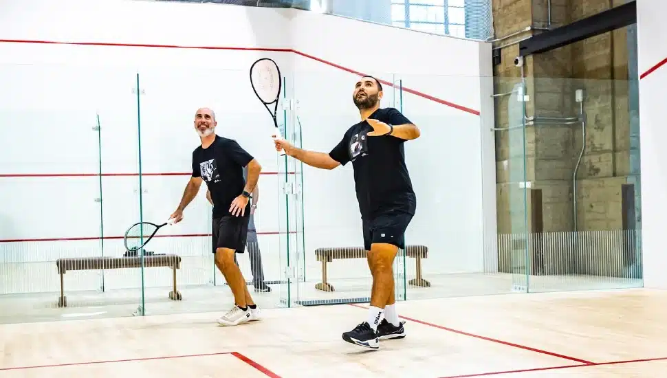 Two guys playing racketball at Ballers