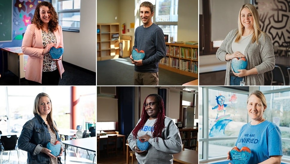 Six teachers hold glass heart awards.