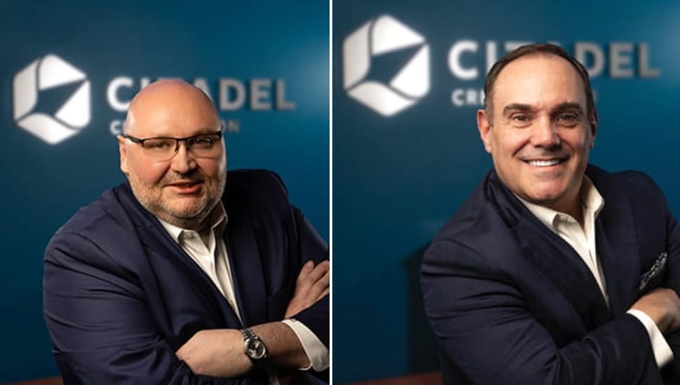 Headshots of two banking executives with arms crossed.