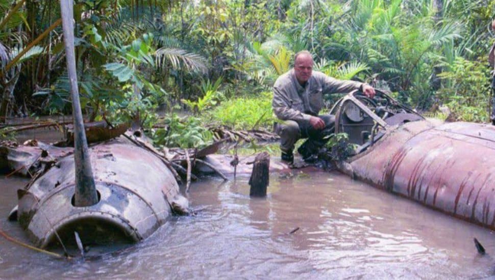 Alfred "Fred" Hagenwith a crashed P38 Lightning in the Ramu River Valley of Palau New Guinea.