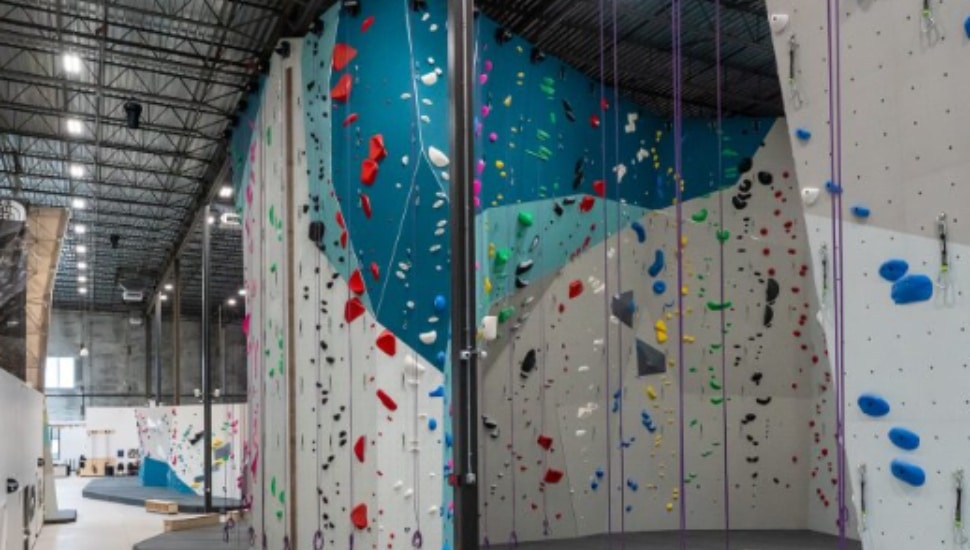 A rock climbing wall inside Movement Gyms.