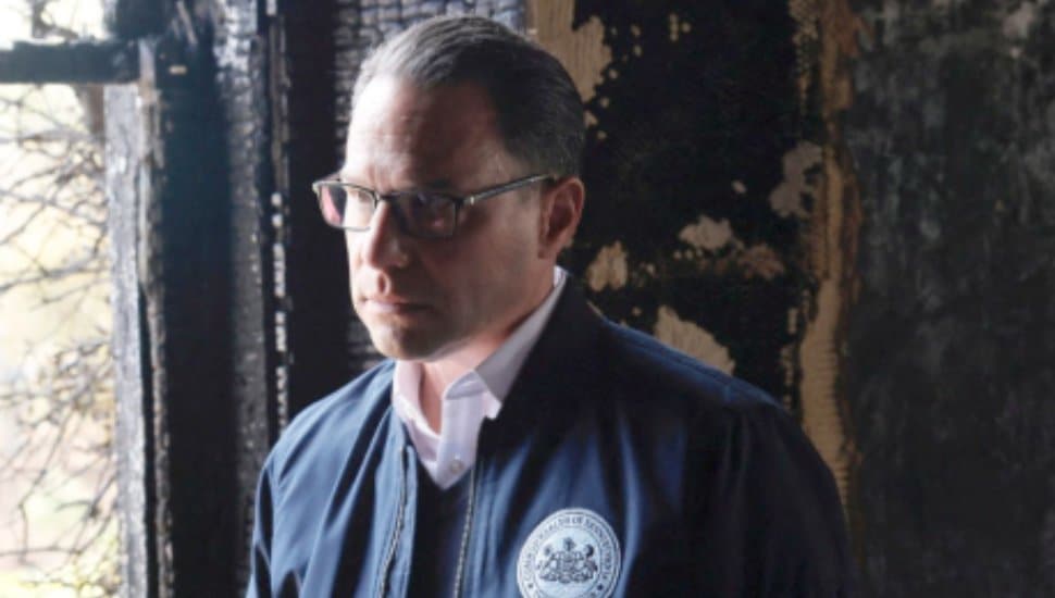 Josh Shapiro stands among the burnt remains of the Governor's Mansion.