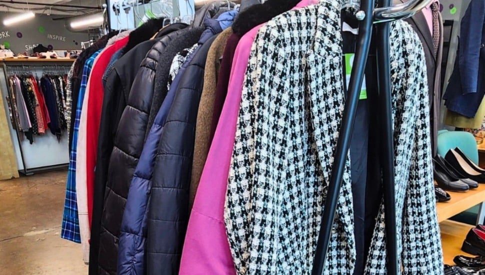 A bunch of winter coats and jackets hanging inside The Wardrobe.