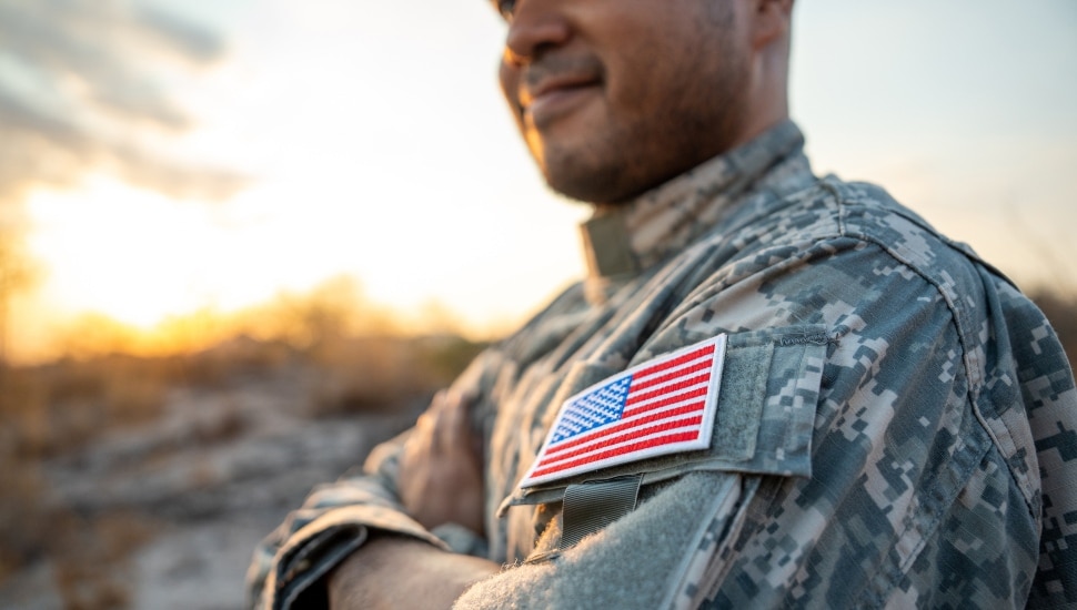 A soldier with an American flag patch on his uniform.