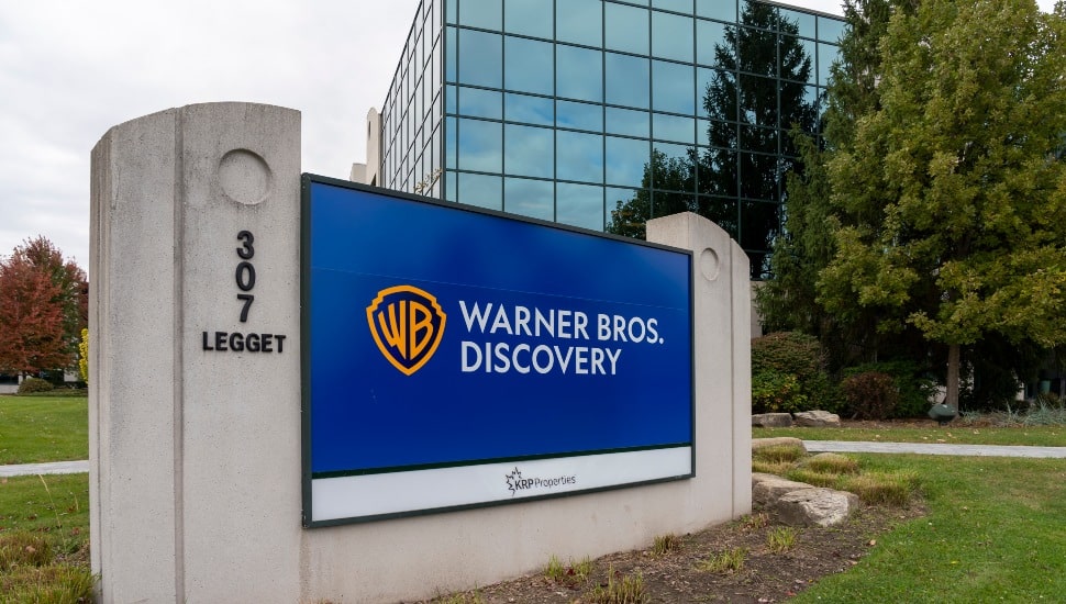 A screen with "Warner Bros. Discovery" and logo on it.