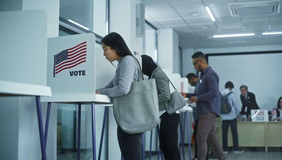 People voting at booths.