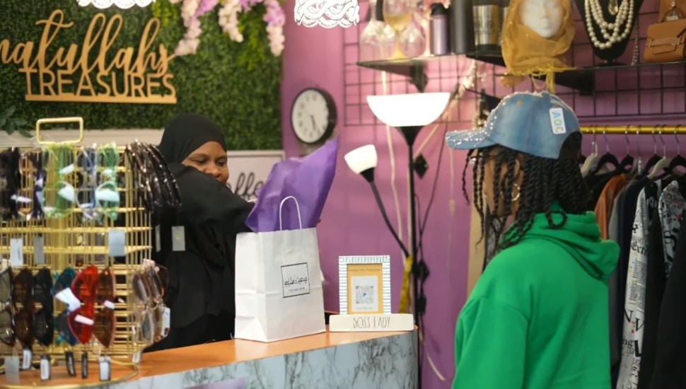 A customer inside Amatullah's Treasures with owner.