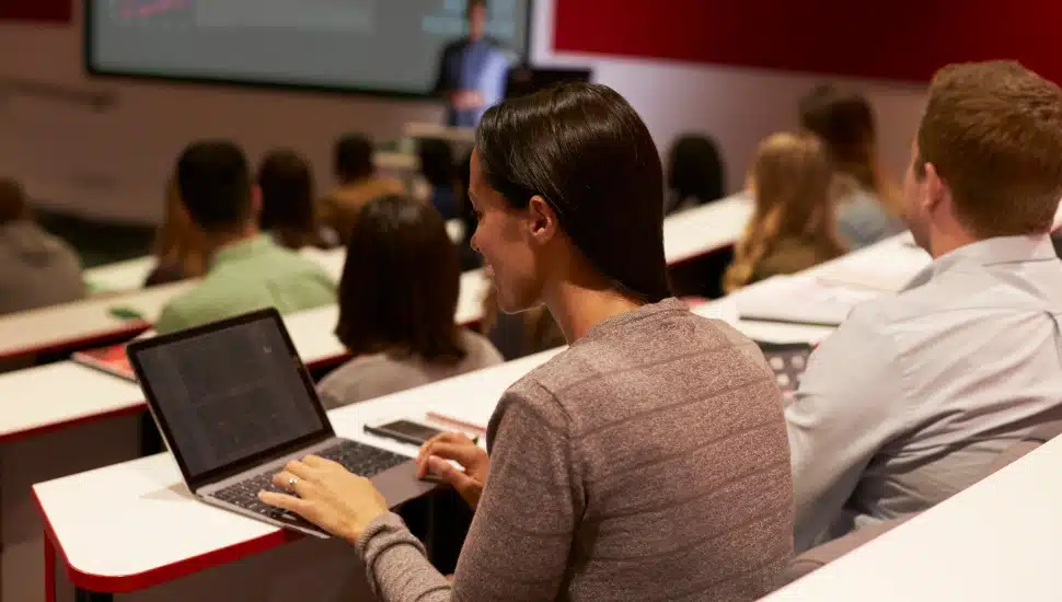 A college student using laptop during lecture