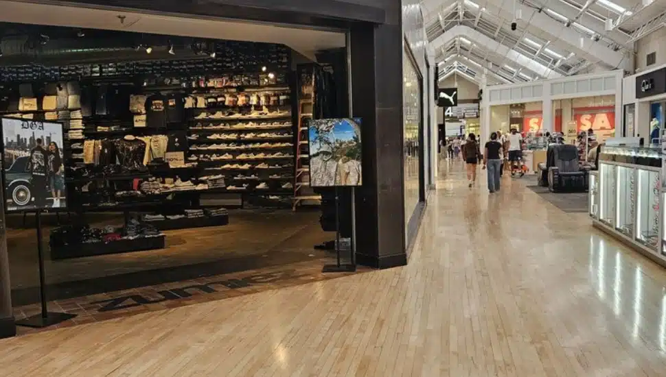Inside a Zumies store at Franklin Mall and people walking into the distance.