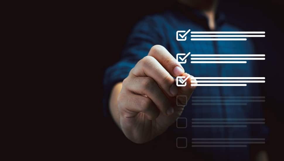 Businessman using pen to tick mark for check review and approve virtual document.