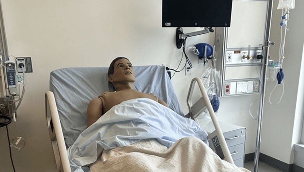 Mannequin in hospital bed.