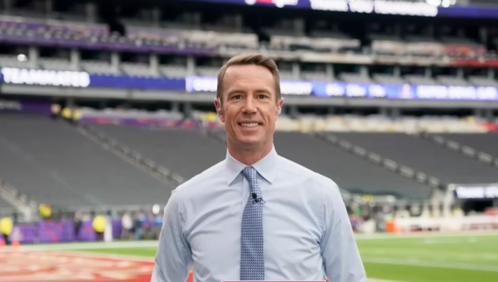 Matt Ryan wearing a tie on a football field directly facing camera.