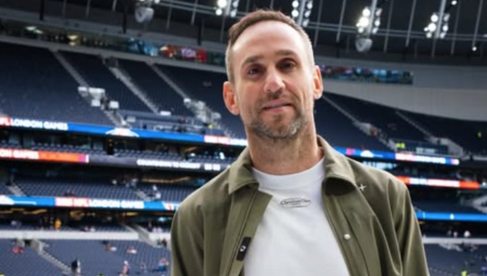 Michael Rubin stands on the pitch at a soccer game.