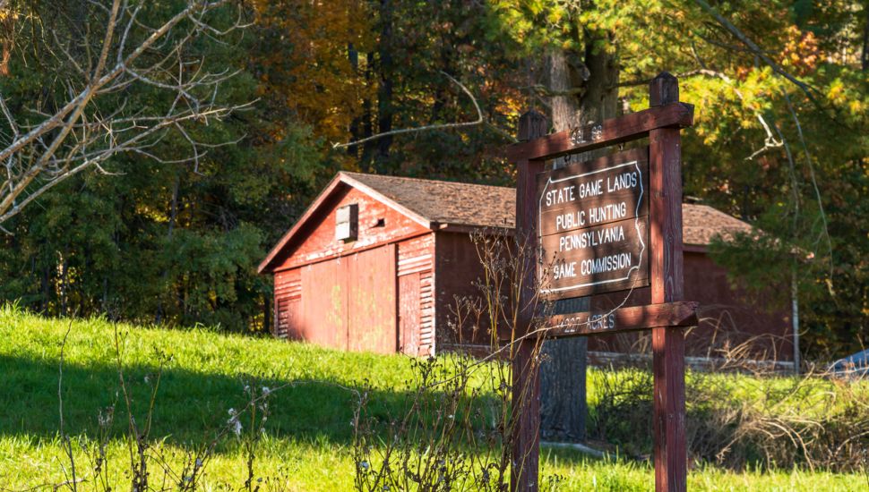A building on top of a hill in Deerfield Township with a Pennsylvania Game Commission Game Land 86 wooden sign on a sunny fall day. Image via iStock.