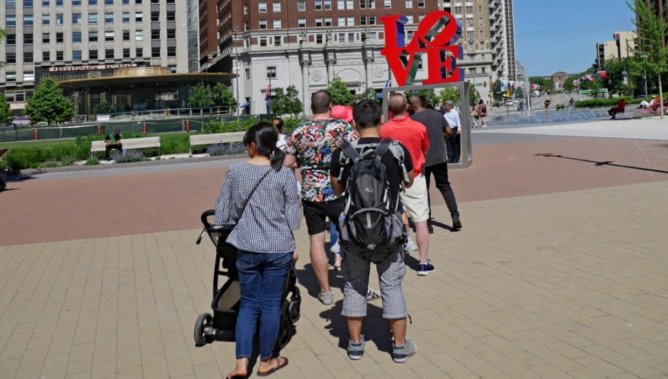 Tourists lining up to be photographed with Philadelphia's pop art LOVE sculpture.