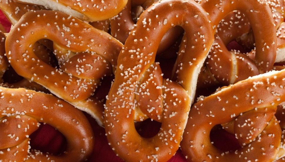 Soft pretzels on a red plate.
